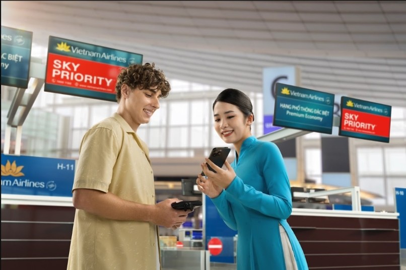 Vietnam Airlines staff helping a passenger at the Sky Priority Premium Economy check-in counter